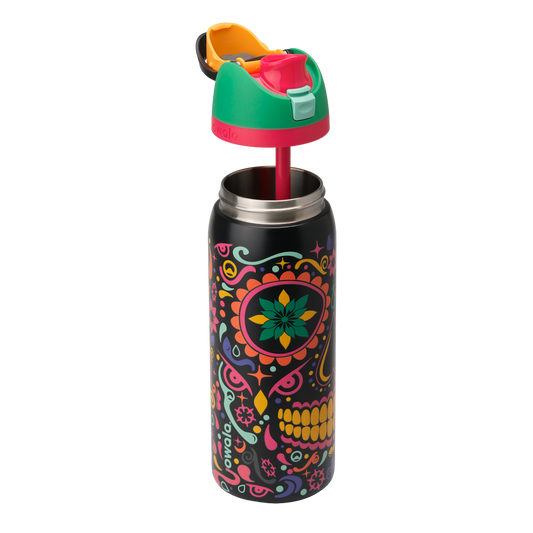 Owala FreeSip Sway 32oz in Sugar Skull, exploded view showing black body with sugar-skull pattern, green flip cap with pink accent ring, orange push-button, and red straw lifted above; glows in the dark