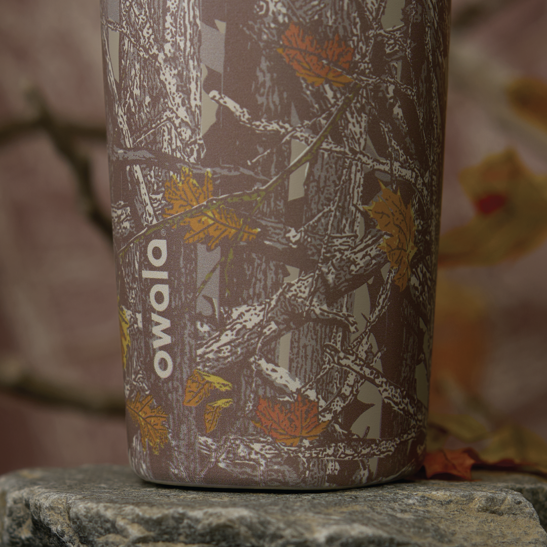 Owala FreeSip Sway in Out of Sight, close-up of woodland camo patterned body with white Owala logo